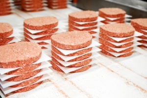 Plant based Impossible Burger Patties In Stacks Uncooked